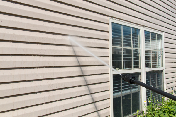 Vinyl siding on home being washed